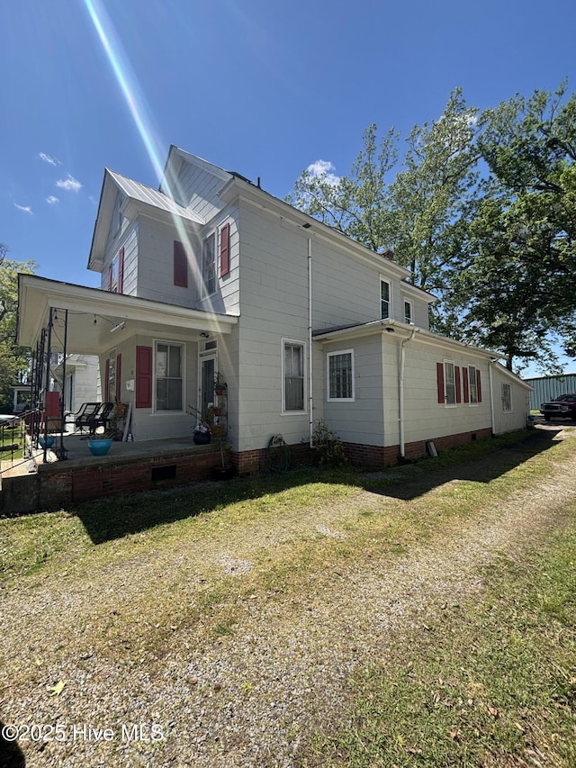 view of side of home featuring a yard