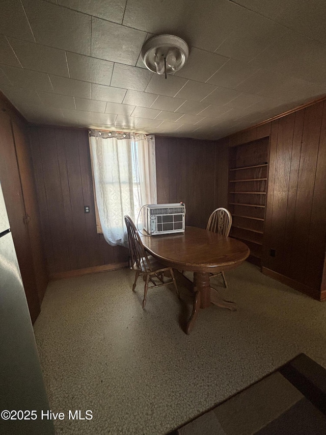 dining room with wooden walls