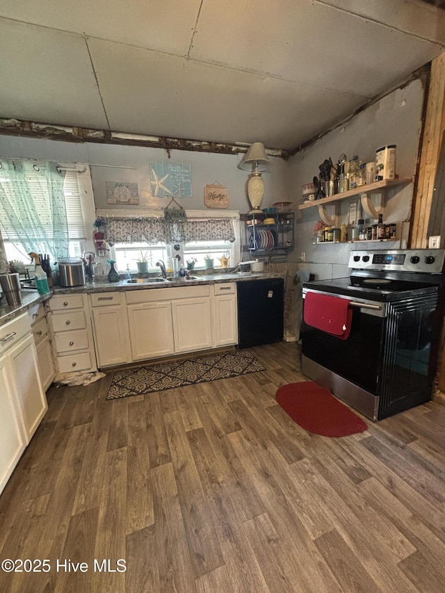 kitchen with black dishwasher, stainless steel range with electric cooktop, white cabinets, and dark wood finished floors