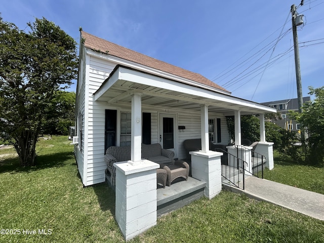 417 Turner St, Beaufort, NC 28516 - back of house with covered porch, a yard, and roof with shingles