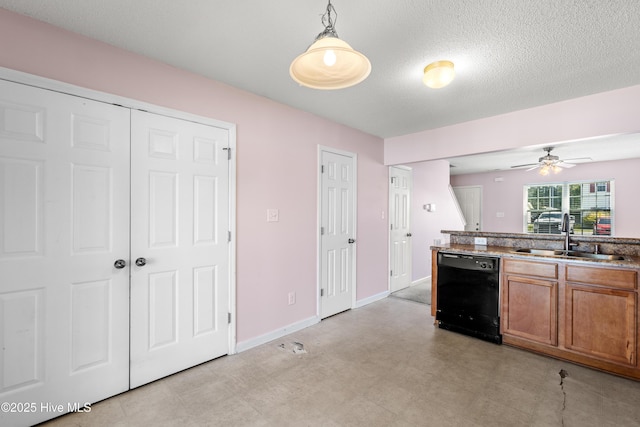 kitchen with brown cabinetry, ceiling fan, black dishwasher, a sink, and hanging light fixtures