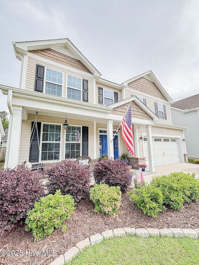 view of front of house featuring an attached garage, a porch, and driveway