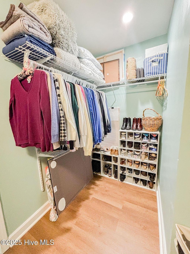 spacious closet with wood finished floors