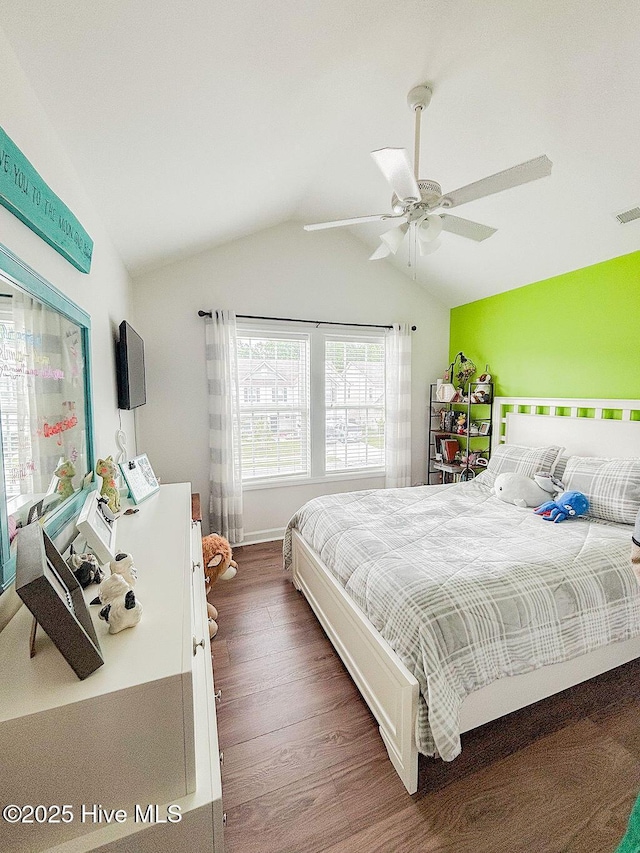 bedroom featuring visible vents, a ceiling fan, wood finished floors, and lofted ceiling
