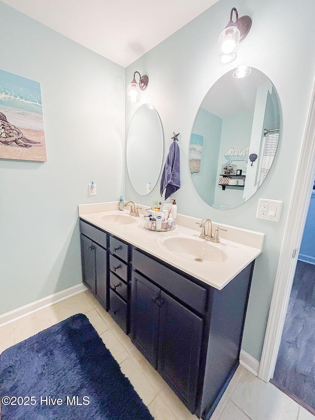 full bathroom featuring a sink, tile patterned floors, and double vanity