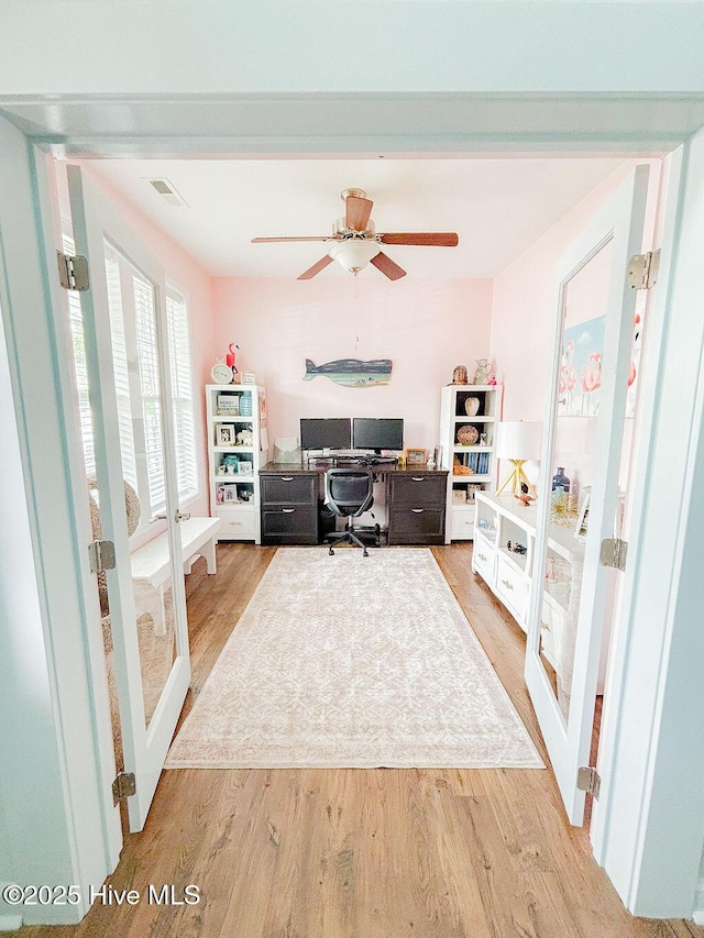 office featuring light wood-type flooring and a ceiling fan
