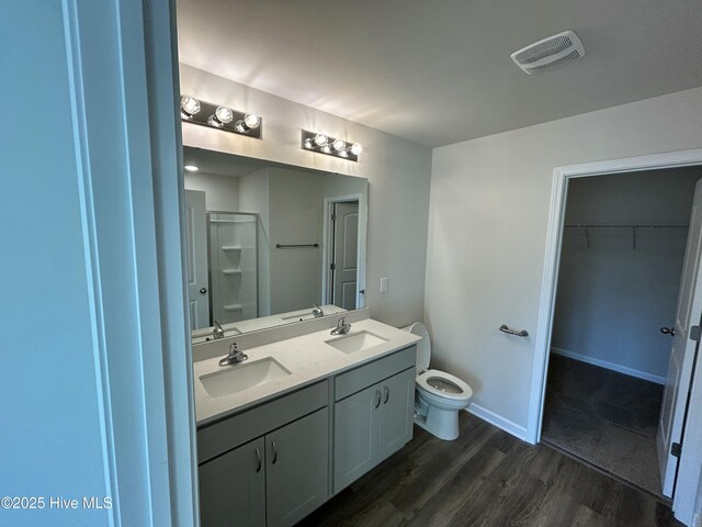 586 Chicod St, Grimesland, NC 27837 - full bathroom featuring visible vents, a sink, wood finished floors, and a stall shower