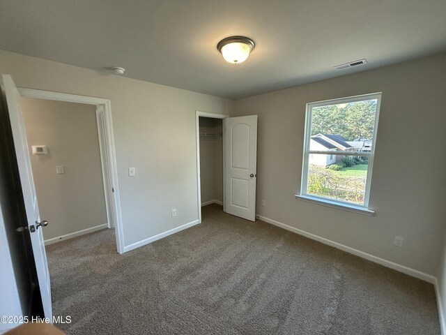 586 Chicod St, Grimesland, NC 27837 - unfurnished bedroom with visible vents, carpet flooring, baseboards, and a closet