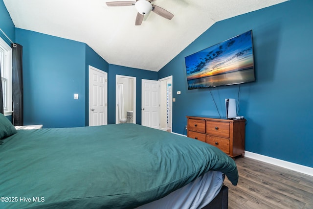 bedroom featuring baseboards, ceiling fan, wood finished floors, and vaulted ceiling