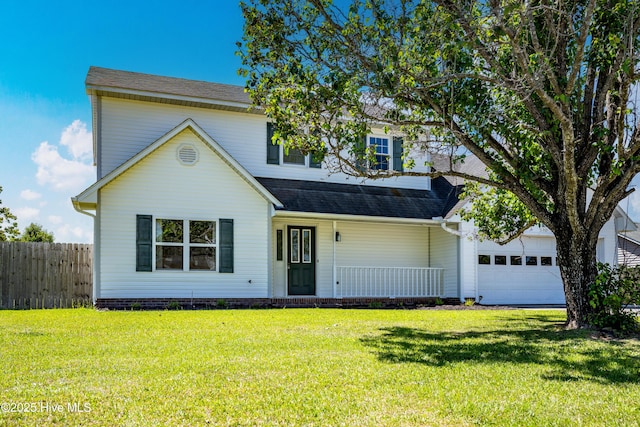 traditional-style home featuring a garage, a front lawn, fence, covered porch, and a shingled roof