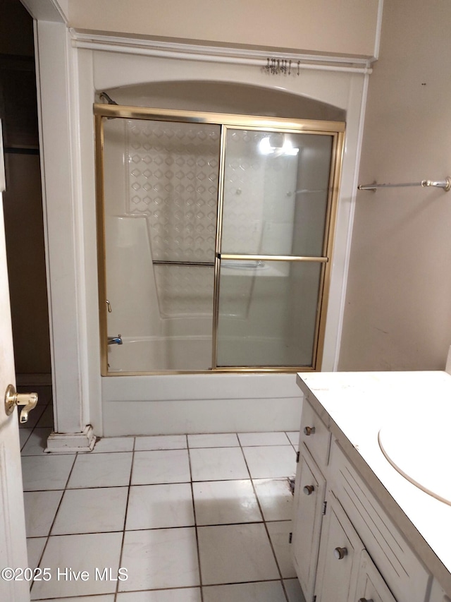 bathroom with vanity, bath / shower combo with glass door, and tile patterned floors