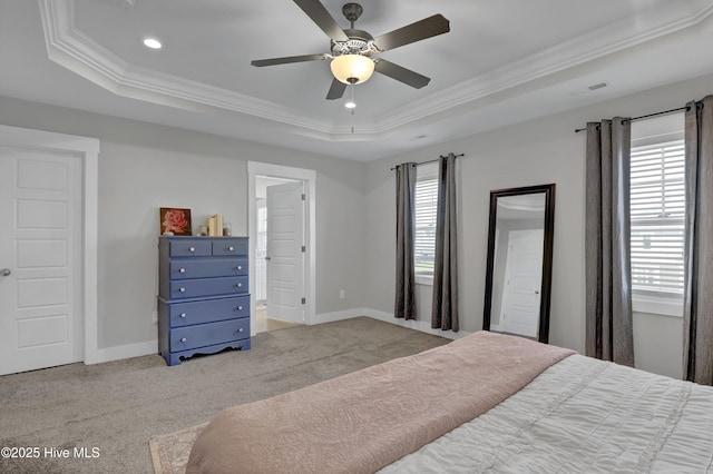 bedroom with a tray ceiling, crown molding, recessed lighting, and light colored carpet