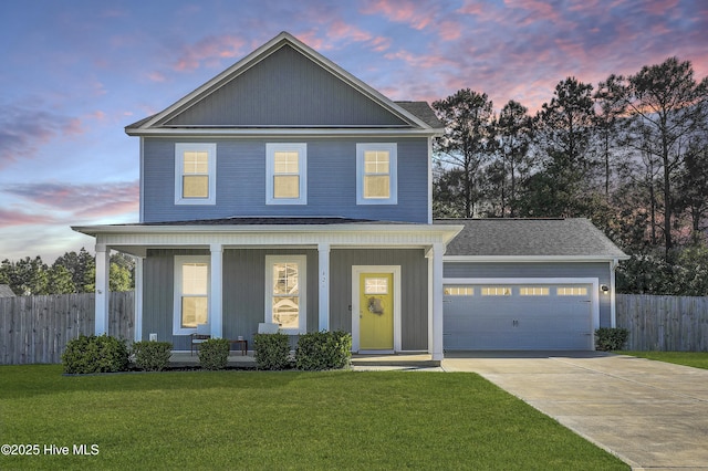 traditional home featuring a garage, fence, concrete driveway, a front yard, and a porch