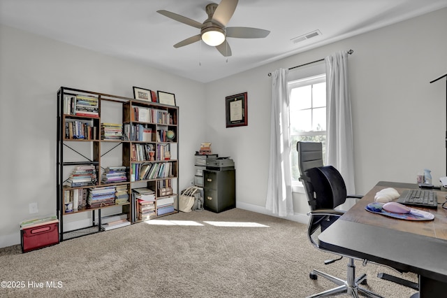 carpeted office space featuring visible vents, baseboards, and ceiling fan