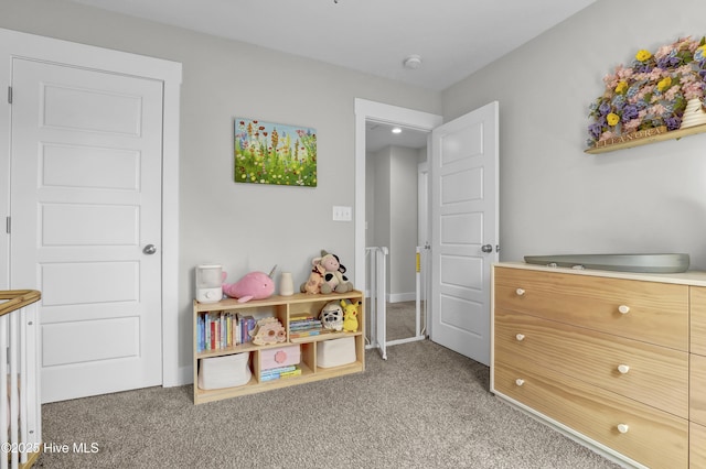 rec room with light colored carpet and baseboards