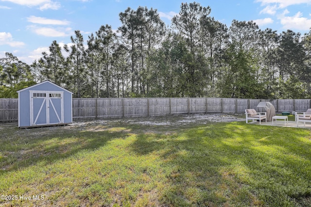 view of yard with a storage shed, an outbuilding, a patio area, and a fenced backyard