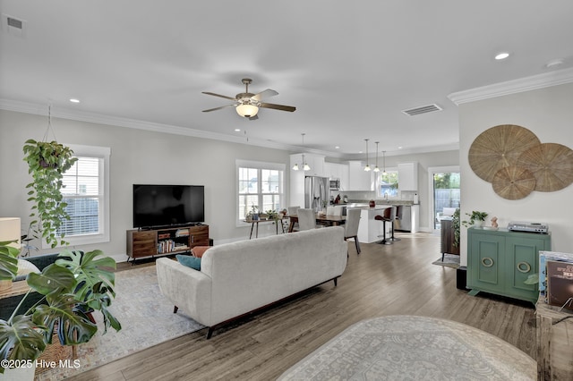 living area with light wood-type flooring, visible vents, and recessed lighting