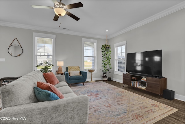 living area with a ceiling fan, baseboards, visible vents, crown molding, and wood finished floors