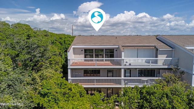 289 Salter Path Rd Unit 32, Pine Knoll Shores, NC 28512 - rear view of house featuring a shingled roof and a balcony