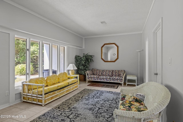 living room with a textured ceiling, tile patterned floors, visible vents, and ornamental molding