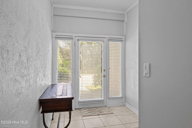 doorway to outside with a textured wall and tile patterned floors