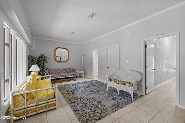tiled living area with crown molding, a textured ceiling, visible vents, and baseboards