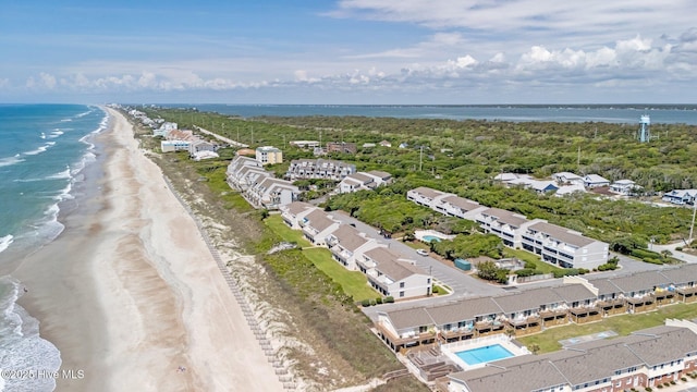 birds eye view of property featuring a beach view and a water view