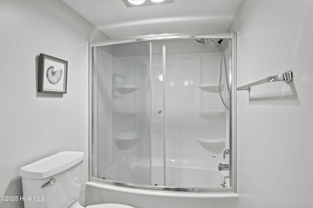 bathroom with enclosed tub / shower combo and toilet