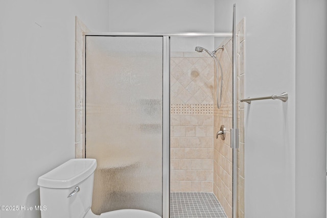 full bath with a stall shower and toilet