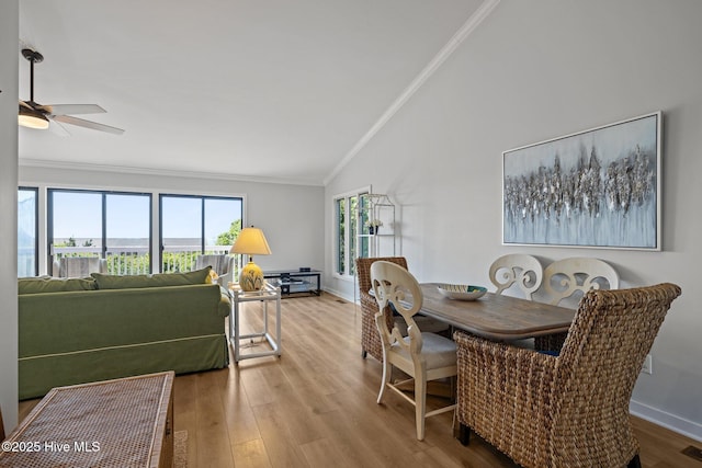 289 Salter Path Rd Unit 32, Pine Knoll Shores, NC 28512 - dining area with crown molding, lofted ceiling, a wealth of natural light, and wood finished floors