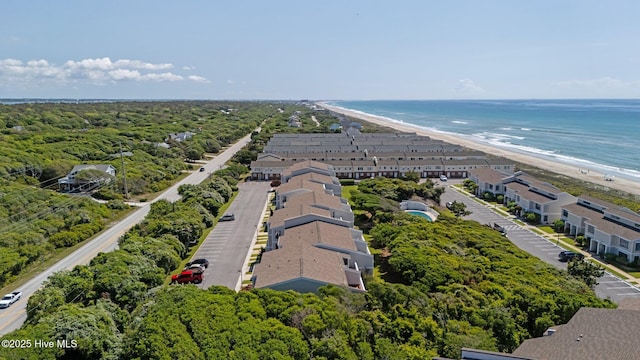 bird's eye view with a water view and a beach view