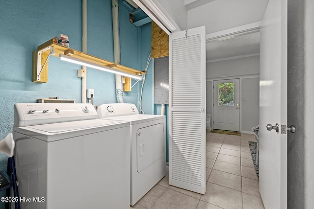 washroom with laundry area, light tile patterned flooring, and independent washer and dryer