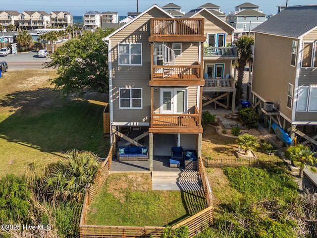 615 N New River Dr Unit E, Surf City, NC 28445 - back of house with a balcony, fence, a patio area, a residential view, and central AC unit