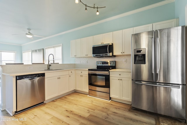 615 N New River Dr Unit E, Surf City, NC 28445 - kitchen featuring crown molding, appliances with stainless steel finishes, a sink, light countertops, and a ceiling fan