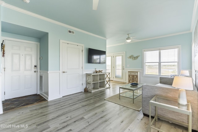 615 N New River Dr Unit E, Surf City, NC 28445 - living area with crown molding, wainscoting, a ceiling fan, and visible vents
