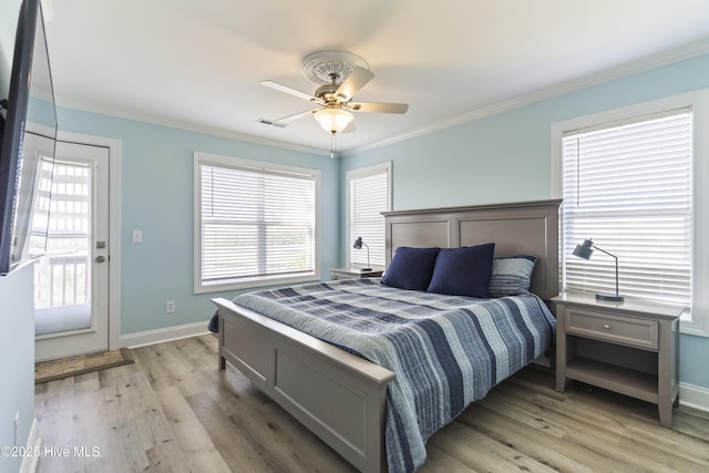 615 N New River Dr Unit E, Surf City, NC 28445 - bedroom with light wood-type flooring, ceiling fan, crown molding, and visible vents
