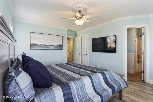 615 N New River Dr Unit E, Surf City, NC 28445 - bedroom with ornamental molding, a ceiling fan, and wood finished floors
