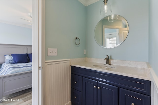 615 N New River Dr Unit E, Surf City, NC 28445 - bathroom featuring wainscoting, crown molding, wood finished floors, and vanity
