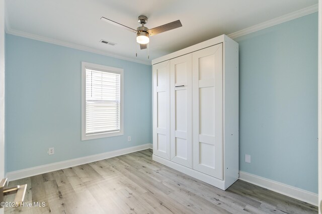 615 N New River Dr Unit E, Surf City, NC 28445 - unfurnished bedroom featuring visible vents, light wood-style flooring, and ornamental molding