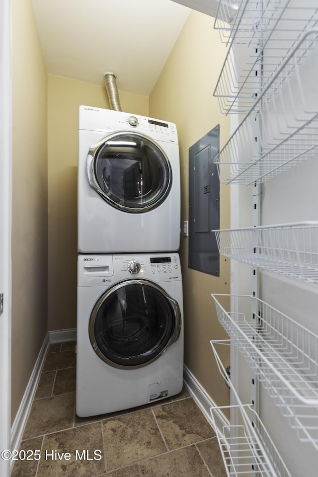 615 N New River Dr Unit E, Surf City, NC 28445 - clothes washing area featuring laundry area, stone tile flooring, baseboards, electric panel, and stacked washer / drying machine