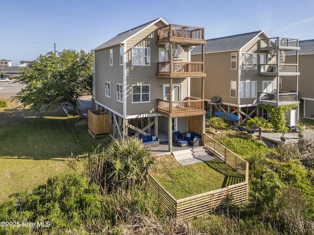 615 N New River Dr Unit E, Surf City, NC 28445 - rear view of house with a balcony, a yard, outdoor lounge area, a patio area, and fence private yard