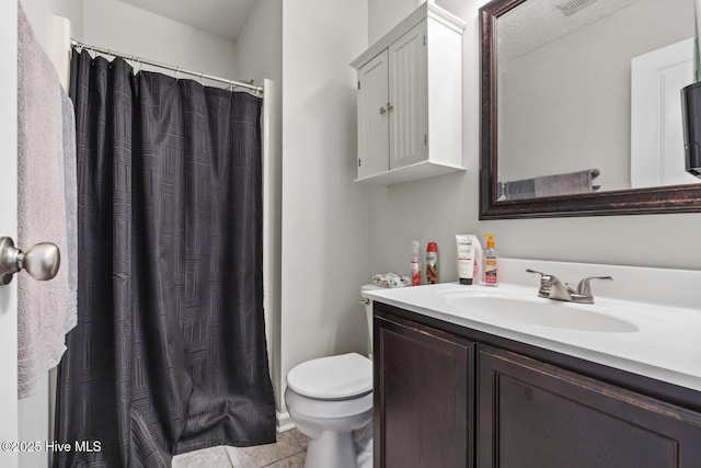 bathroom with visible vents, curtained shower, tile patterned floors, vanity, and toilet