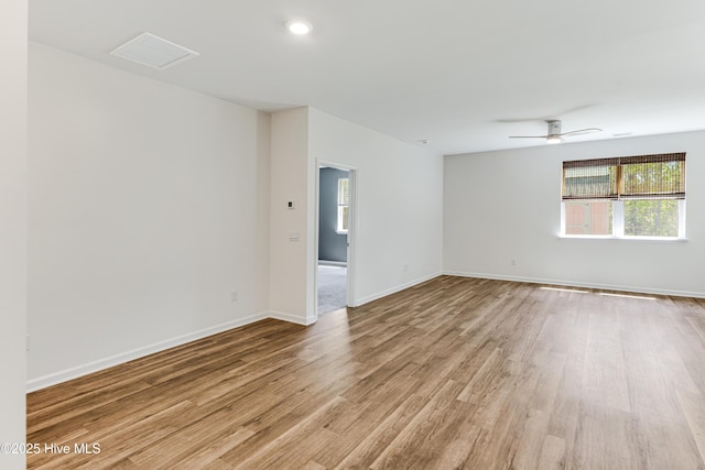empty room with a ceiling fan, baseboards, visible vents, and light wood-style flooring