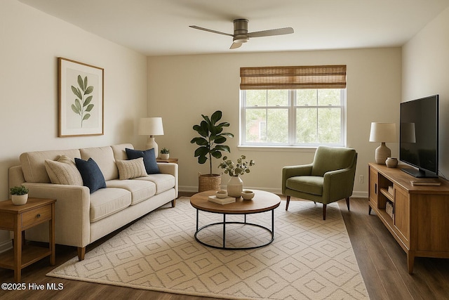 living area with baseboards, a ceiling fan, and wood finished floors