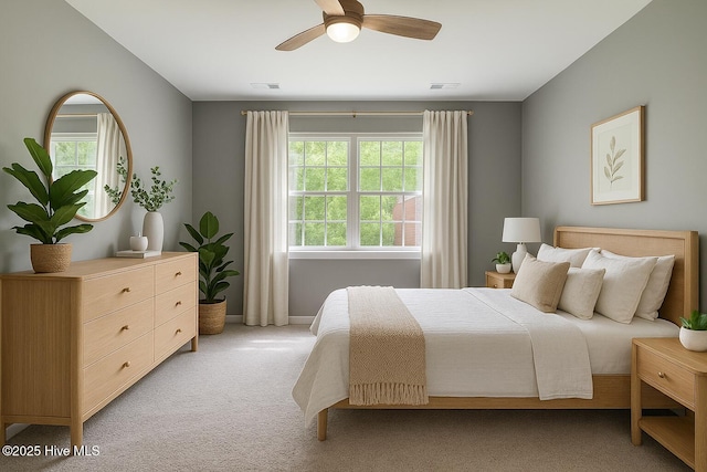 bedroom with baseboards, visible vents, a ceiling fan, and light colored carpet