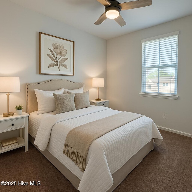 bedroom featuring baseboards, ceiling fan, and dark carpet