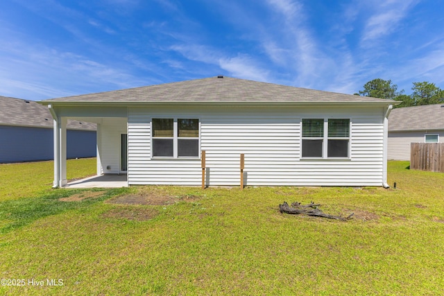 back of property with a lawn, fence, and a patio area