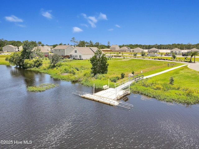 birds eye view of property with a water view and a residential view