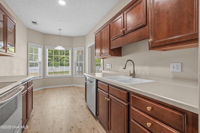 kitchen featuring visible vents, white electric range, dishwasher, a sink, and light wood finished floors