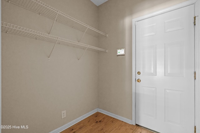 washroom featuring light wood-style floors and baseboards